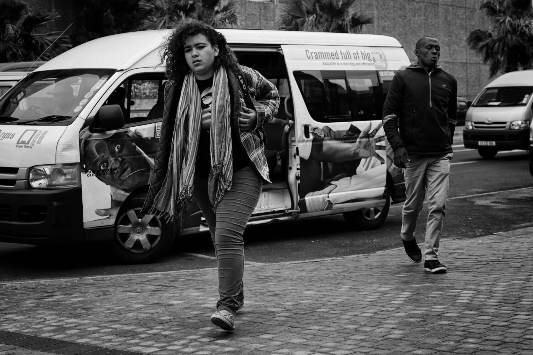 A taxi releases passengers onto the streets of Cape Town