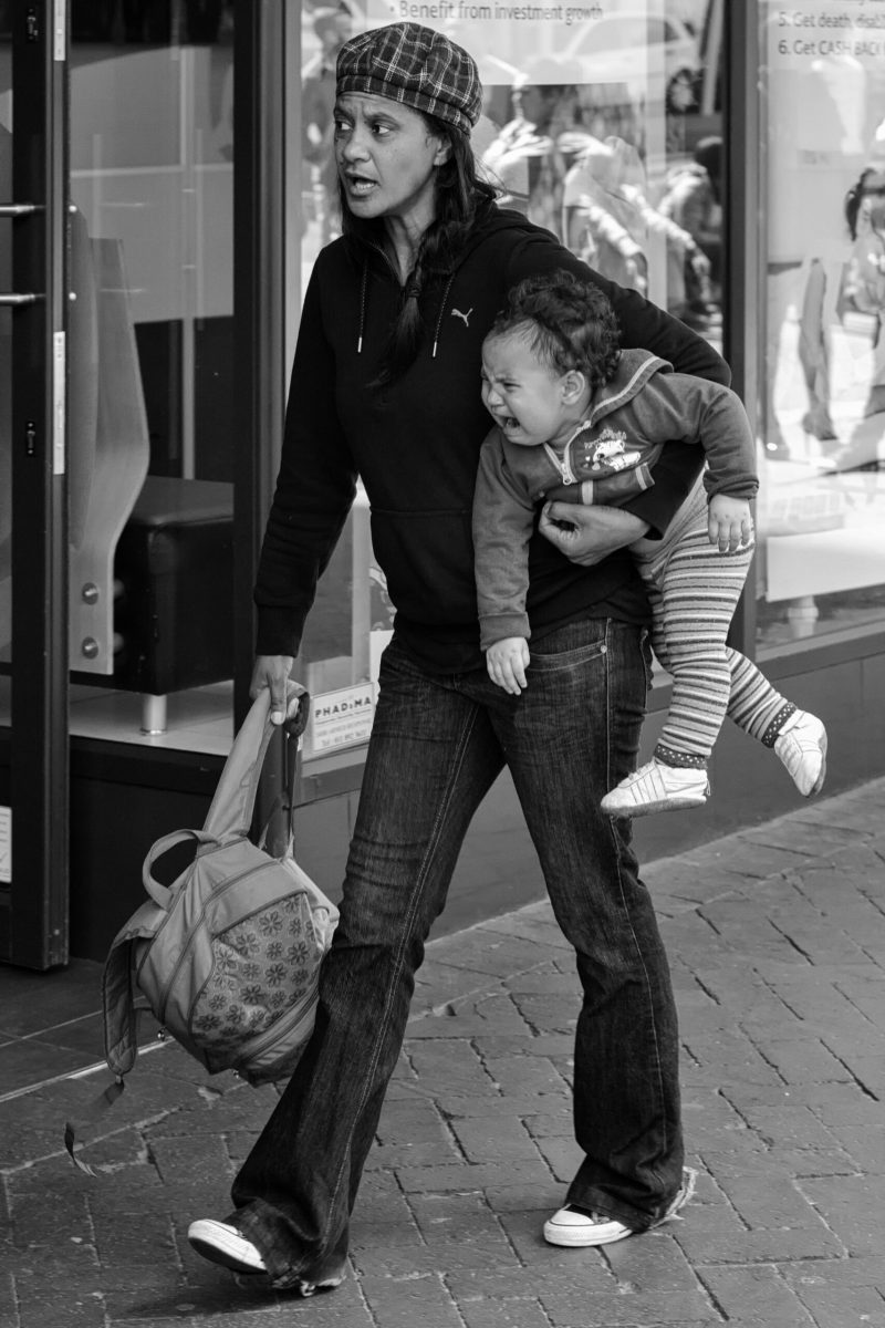A child is carried unhappily